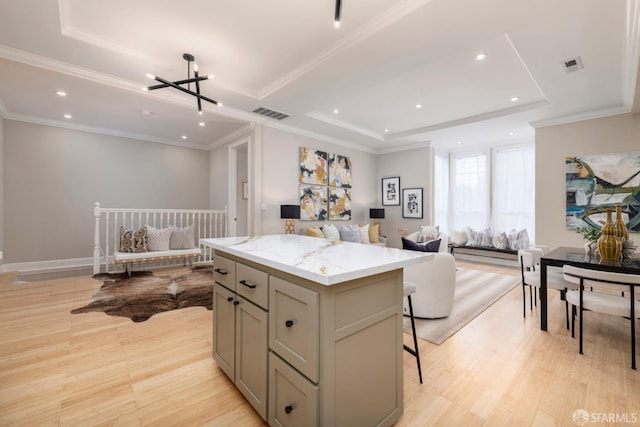 2675 Sutter St, San Francisco, CA 94115 - kitchen featuring open floor plan, a tray ceiling, a center island, recessed lighting, and light wood-style flooring