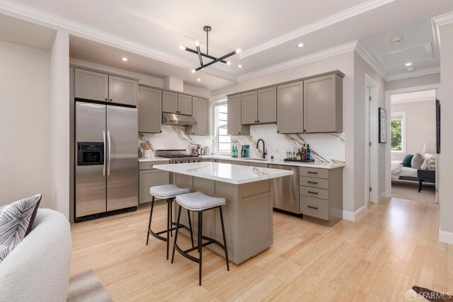 2675 Sutter St, San Francisco, CA 94115 - kitchen with stainless steel appliances, gray cabinetry, light wood-style floors, tasteful backsplash, and recessed lighting