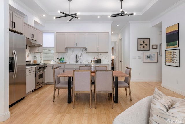 2675 Sutter St, San Francisco, CA 94115 - kitchen with appliances with stainless steel finishes, a chandelier, decorative backsplash, crown molding, and gray cabinetry