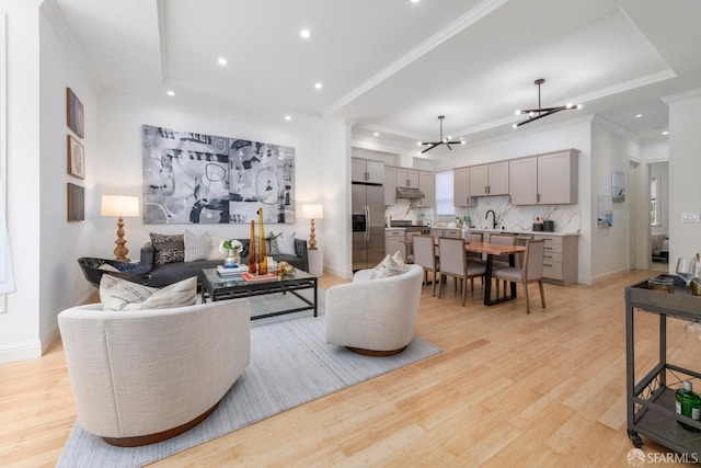 2675 Sutter St, San Francisco, CA 94115 - living room with a chandelier, light wood-style flooring, crown molding, recessed lighting, and a raised ceiling