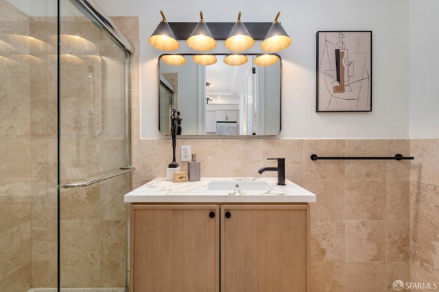2675 Sutter St, San Francisco, CA 94115 - bathroom featuring tile walls, a shower stall, vanity, and wainscoting