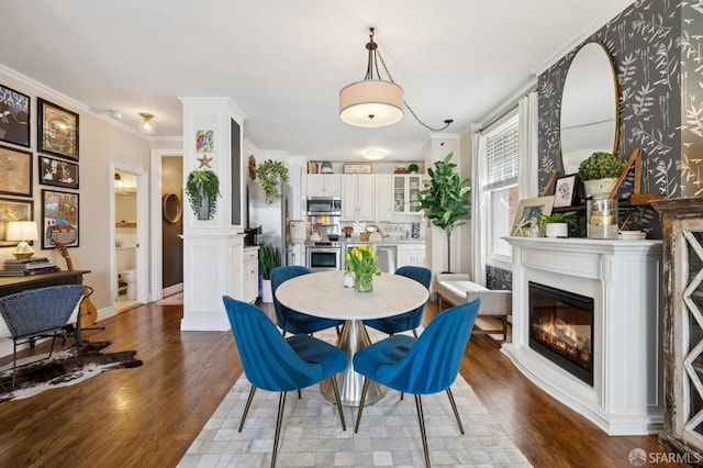 1201 California St Unit 205, San Francisco, CA 94109 - dining space featuring dark wood-style floors, a glass covered fireplace, and ornamental molding