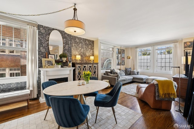 1201 California St Unit 205, San Francisco, CA 94109 - dining space featuring wallpapered walls, wood finished floors, a fireplace, and ornamental molding