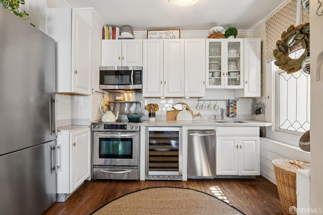 1201 California St Unit 205, San Francisco, CA 94109 - kitchen featuring stainless steel appliances, beverage cooler, light countertops, white cabinetry, and ornamental molding