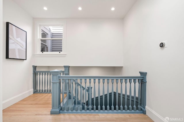 stairway with hardwood / wood-style flooring