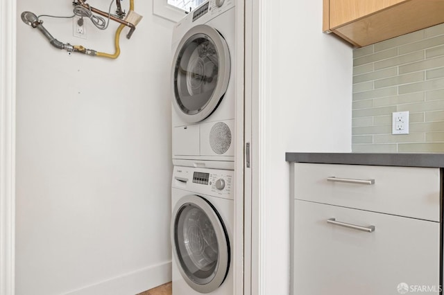 washroom with stacked washer and clothes dryer