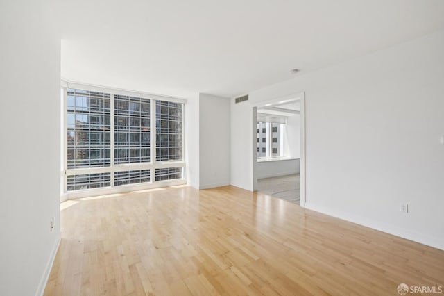 301 Mission St Unit 16H, San Francisco, CA 94105 - empty room with wood finished floors and baseboards