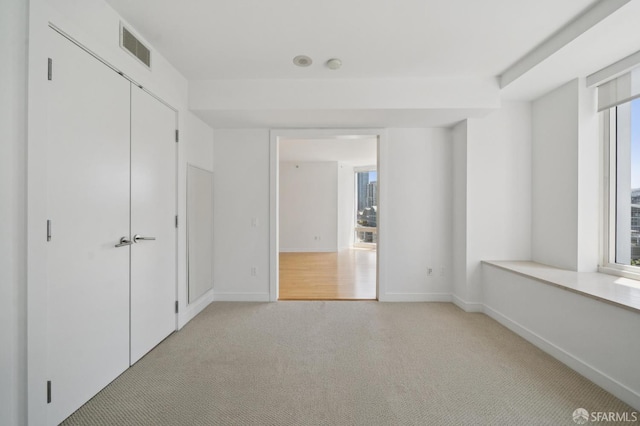 301 Mission St Unit 16H, San Francisco, CA 94105 - unfurnished bedroom with light carpet and baseboards
