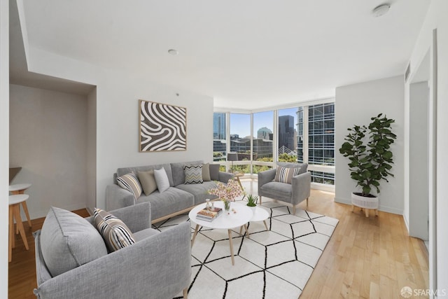 301 Mission St Unit 16H, San Francisco, CA 94105 - living room featuring light wood-style flooring, a wall of windows, and a city view