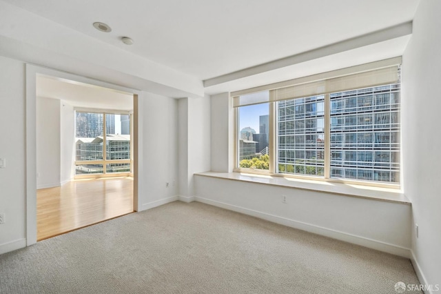 301 Mission St Unit 16H, San Francisco, CA 94105 - carpeted empty room featuring baseboards and a smoke detector