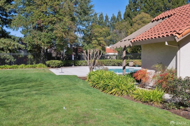 view of yard featuring a fenced in pool and a patio