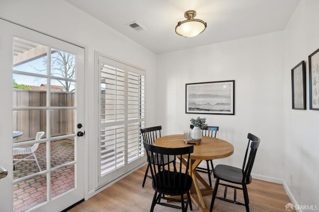 dining space featuring light wood-type flooring