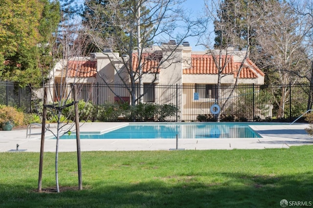 view of pool with a lawn