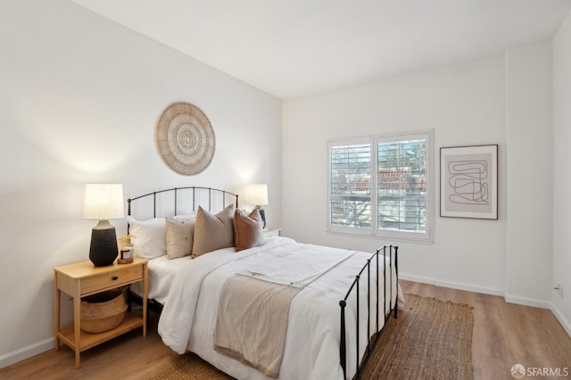 bedroom with hardwood / wood-style floors