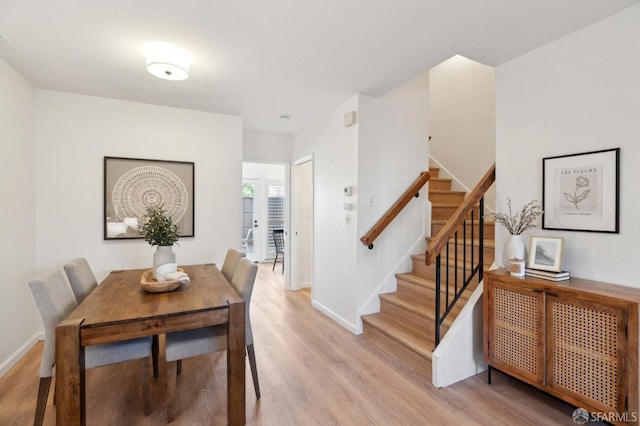 dining space with light hardwood / wood-style flooring