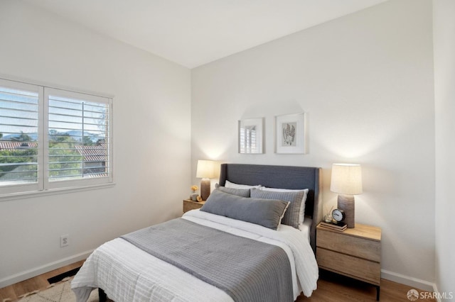 bedroom with hardwood / wood-style flooring