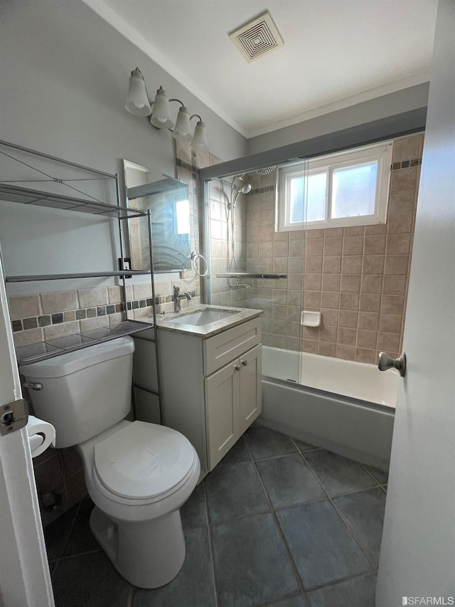 full bathroom with tile patterned floors, toilet, backsplash, tiled shower / bath combo, and vanity