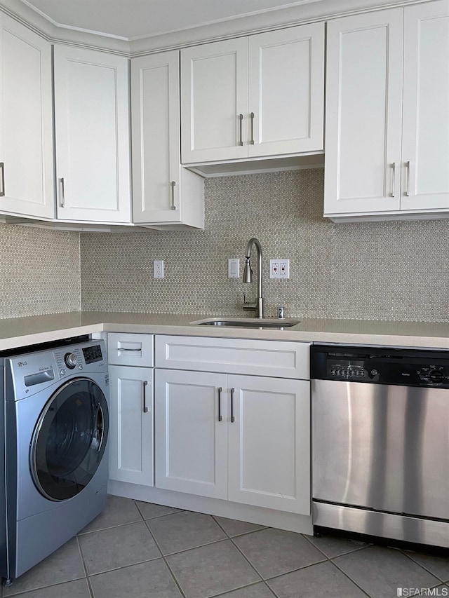 laundry area with washer / dryer, sink, and light tile patterned flooring