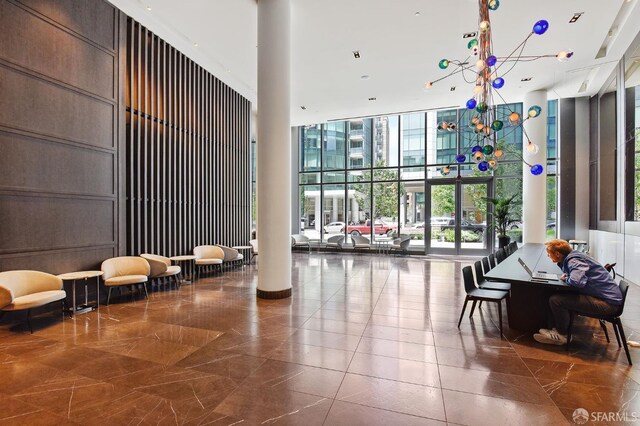 338 Main St Unit 19G, San Francisco, CA 94105 - common area featuring expansive windows and a towering ceiling