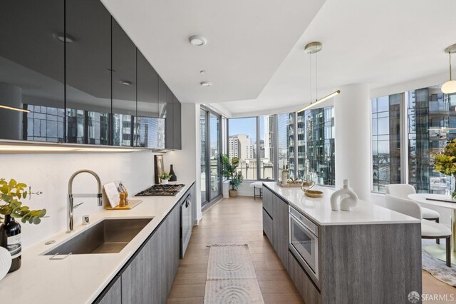 338 Main St Unit 19G, San Francisco, CA 94105 - kitchen featuring modern cabinets, appliances with stainless steel finishes, light wood-type flooring, and light countertops