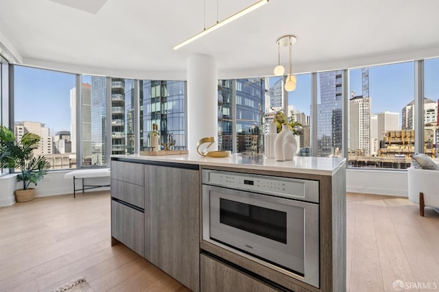 338 Main St Unit 19G, San Francisco, CA 94105 - kitchen with a city view, modern cabinets, light wood-type flooring, and light countertops