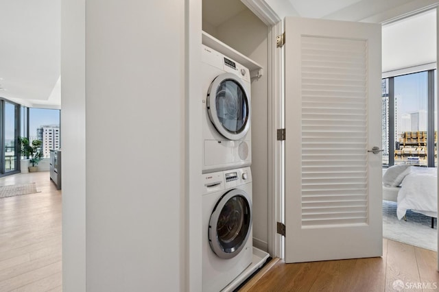 338 Main St Unit 19G, San Francisco, CA 94105 - laundry area with estacked washer and dryer, wood finished floors, and healthy amount of natural light