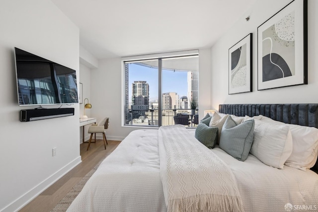 338 Main St Unit 19G, San Francisco, CA 94105 - bedroom with wood finished floors and a city view