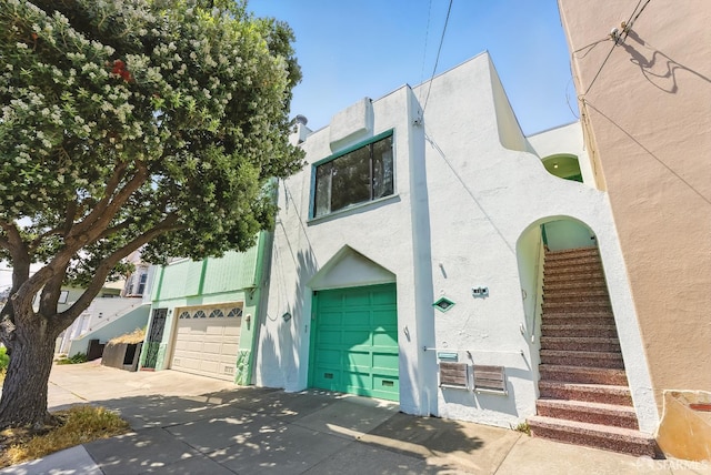 166 Joost Ave, San Francisco, CA 94131 - view of front of home featuring a garage, stucco siding, driveway, and stairs