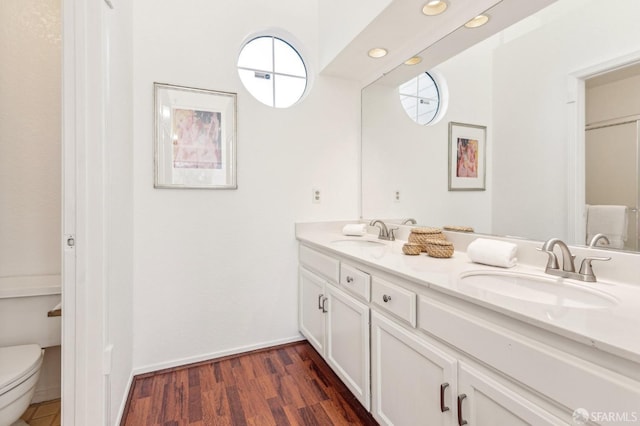 bathroom featuring vanity, hardwood / wood-style floors, and toilet