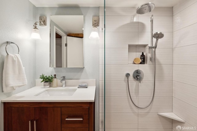 bathroom with vanity and tiled shower