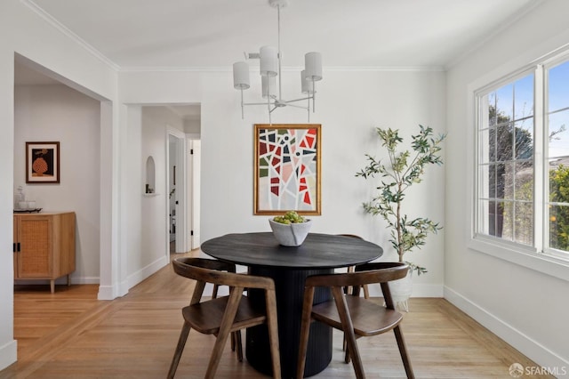 dining room with baseboards, an inviting chandelier, and crown molding