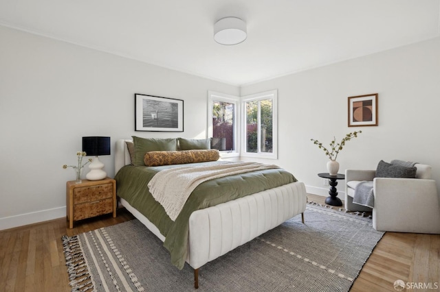 bedroom with wood finished floors and baseboards