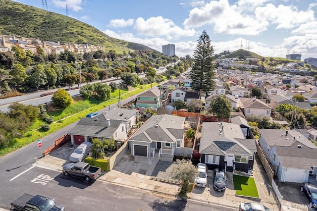 drone / aerial view featuring a residential view and a mountain view