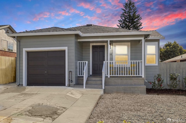 ranch-style home with a porch, concrete driveway, fence, and a garage
