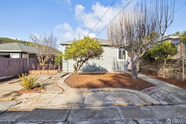 view of front facade featuring fence