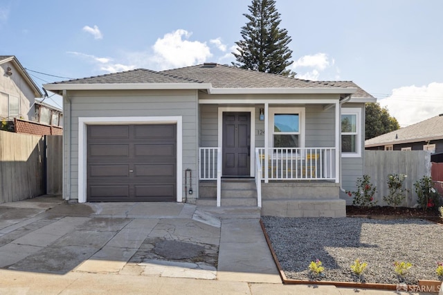 view of front of house featuring an attached garage, covered porch, a shingled roof, fence, and concrete driveway