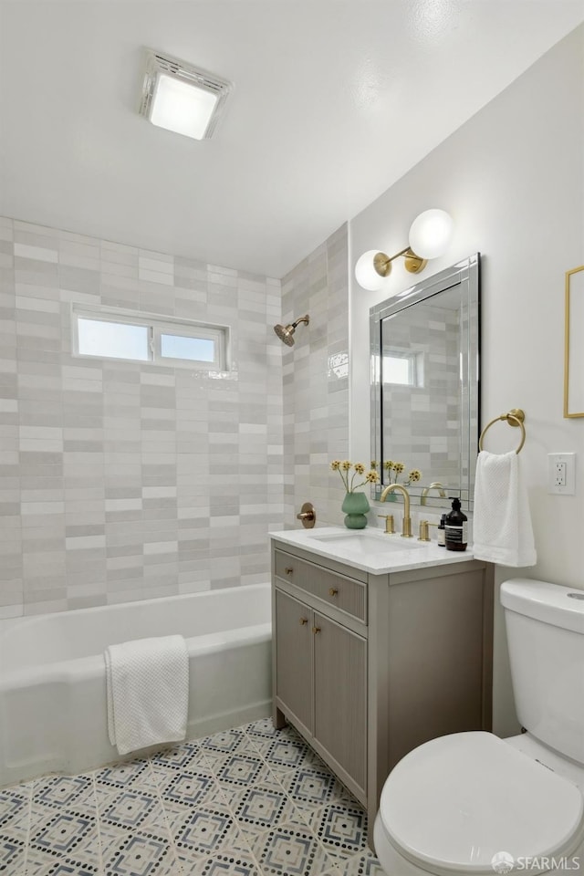 bathroom with vanity, shower / tub combination, and toilet