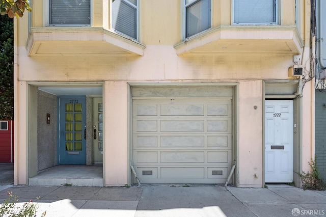 2773-2777 Bryant St, San Francisco, CA 94110 - view of exterior entry with a garage and concrete driveway