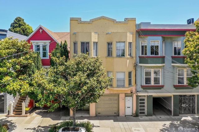 2773-2777 Bryant St, San Francisco, CA 94110 - view of building exterior with a garage and driveway