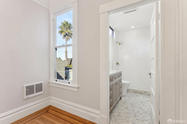 bathroom featuring a stall shower, a healthy amount of sunlight, visible vents, and toilet