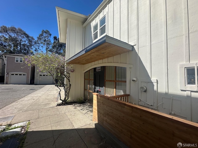 view of home's exterior with board and batten siding and a garage