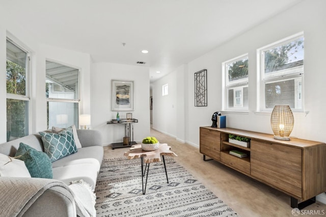 living room featuring recessed lighting, light colored carpet, visible vents, and baseboards