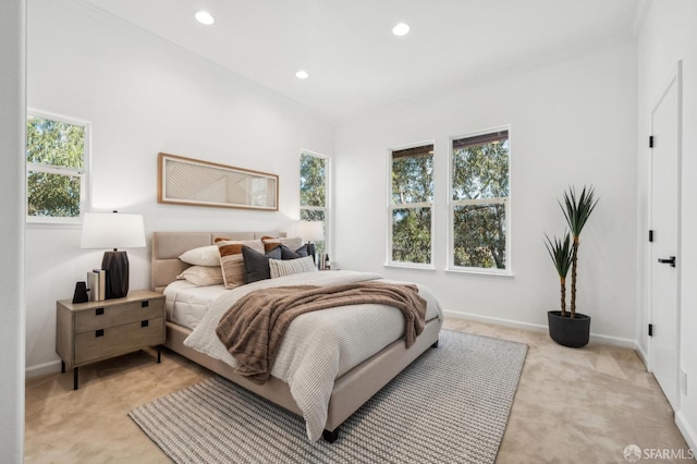 bedroom with light colored carpet, multiple windows, baseboards, and recessed lighting