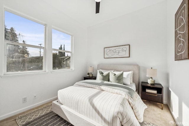 bedroom with a ceiling fan and baseboards