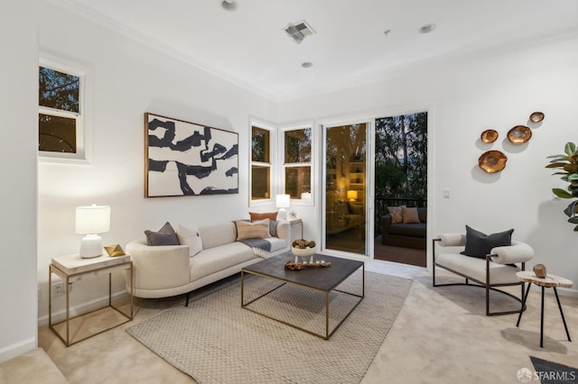 living area with visible vents, crown molding, and baseboards