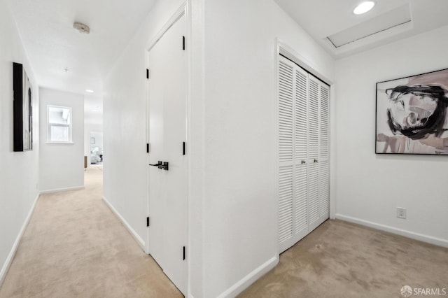 hallway with carpet floors, attic access, baseboards, and recessed lighting