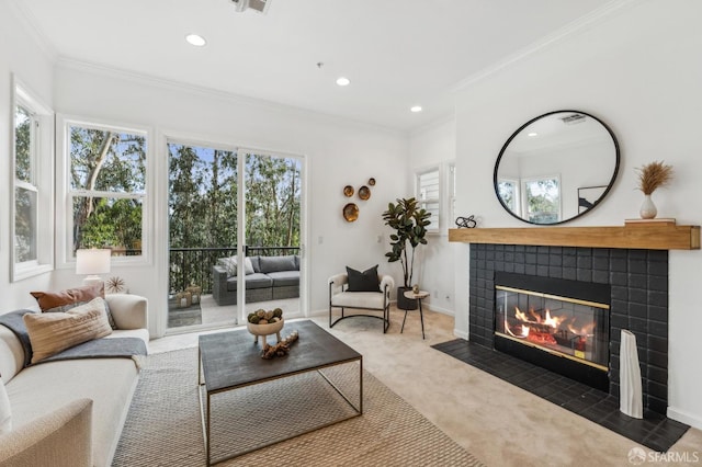 carpeted living area with recessed lighting, baseboards, ornamental molding, and a tile fireplace