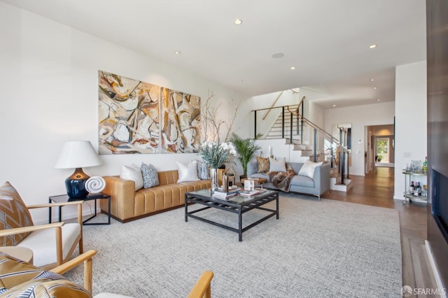 living area featuring recessed lighting, wood finished floors, and stairs