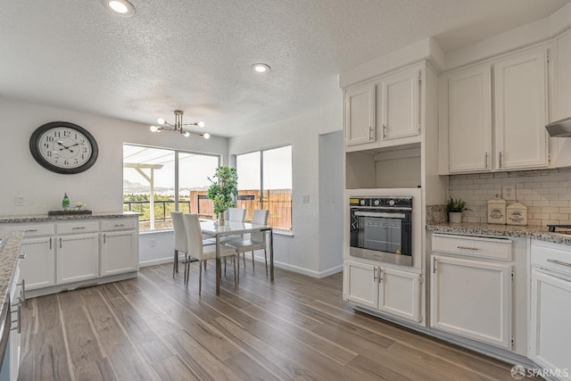 4156 N Amargosa Dr N, Antioch, CA 94531 - kitchen with stainless steel oven, white cabinets, a textured ceiling, backsplash, and recessed lighting