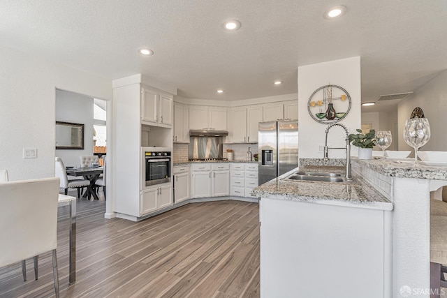 4156 N Amargosa Dr N, Antioch, CA 94531 - kitchen featuring stainless steel appliances, light wood-type flooring, white cabinetry, light stone countertops, and recessed lighting